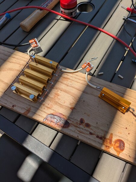 Wire wound resistors and shunt resistors, all connected on a wooden board